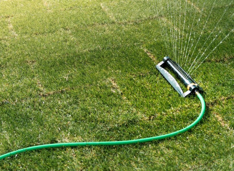 water-sprinkler-spraying-water-on-freshly-laid-gre-2022-04-26-01-48-39-utc