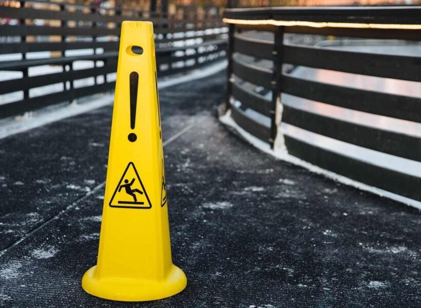 yellow-warning-sign-stands-on-grey-asphalt-covered-2021-10-21-03-37-04-utc